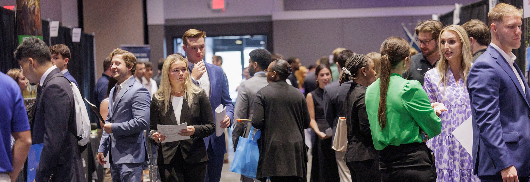 A group of men and women attending a conference.