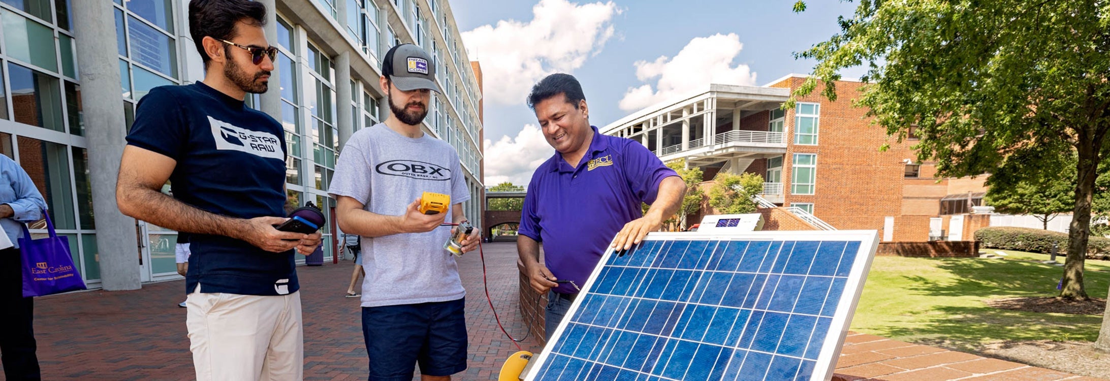 Students and faculty review the proper use of solar panels.